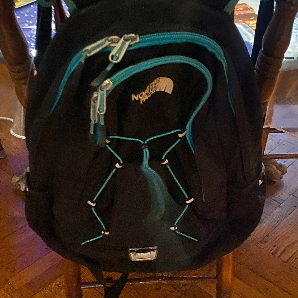 The North Face Jester Black Backpack with Teal Straps